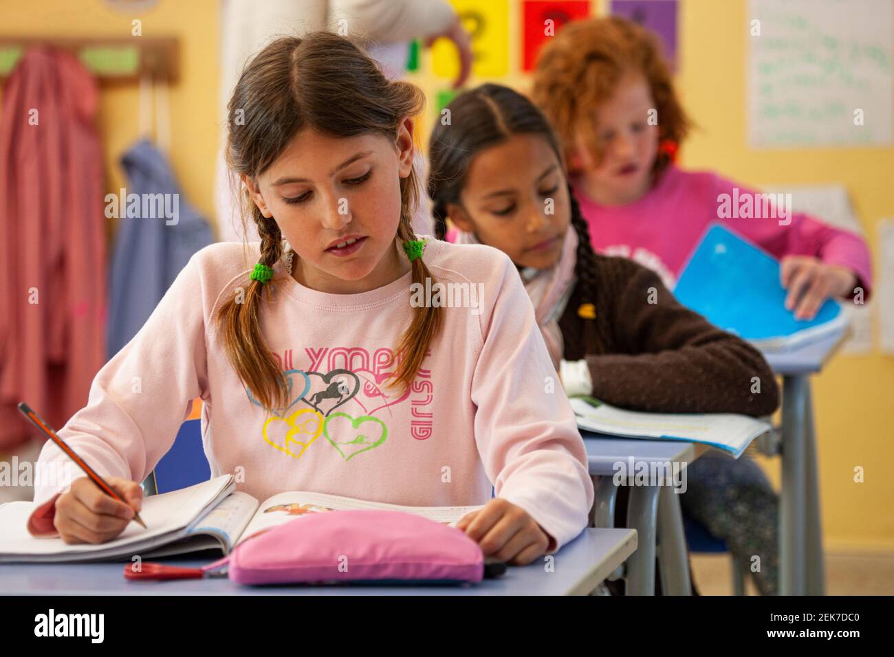 Young girls studying in a school classroom Stock Photo - Alamy