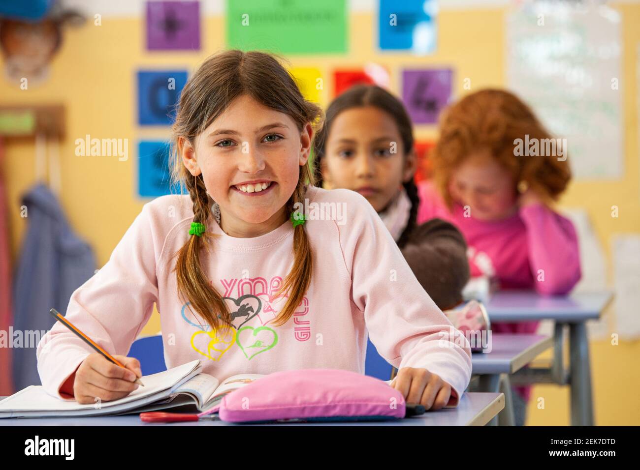 Young girl looking to camera in a school classroom Stock Photo - Alamy