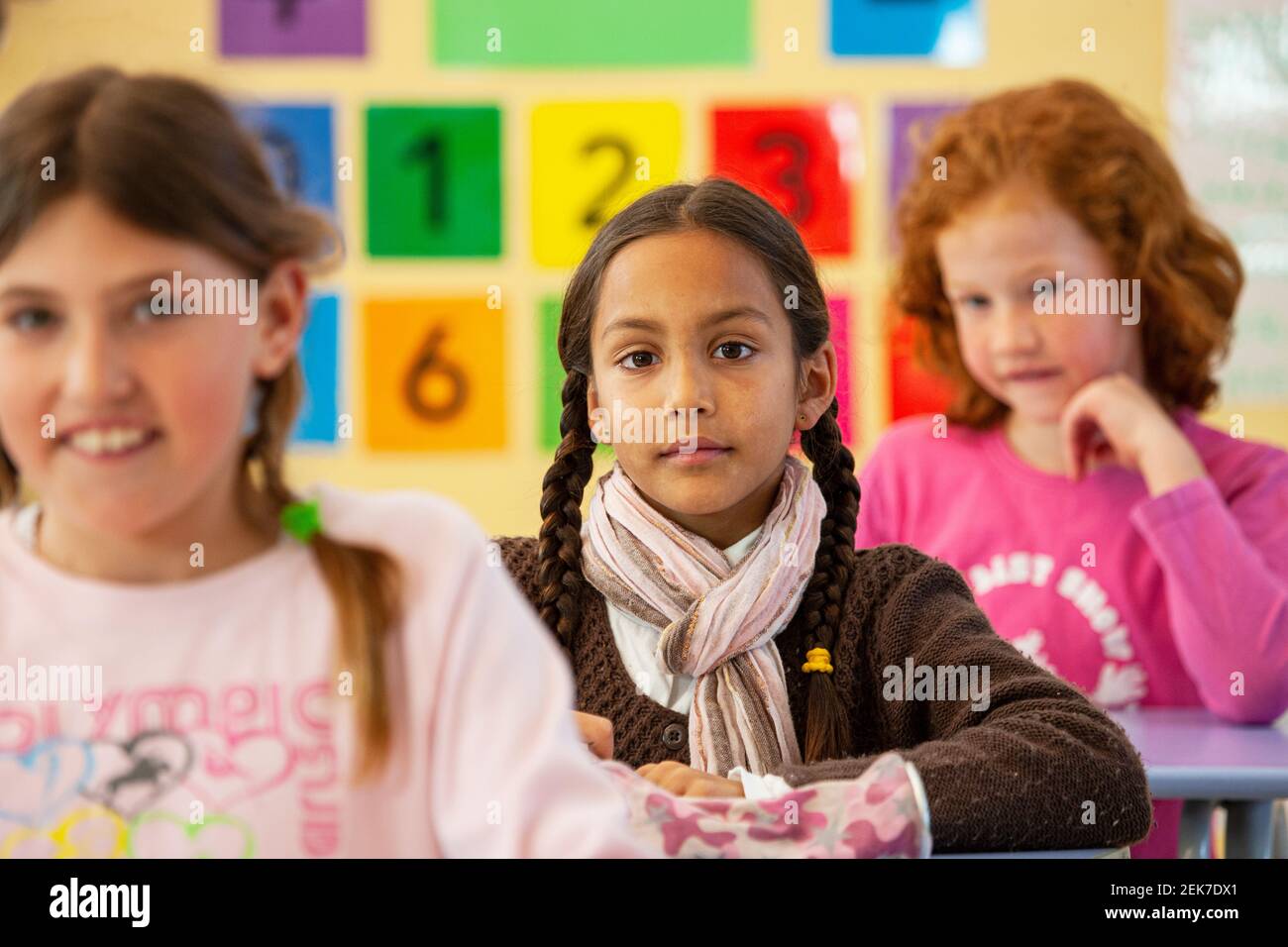 Young girl looking to camera in a school classroom Stock Photo - Alamy