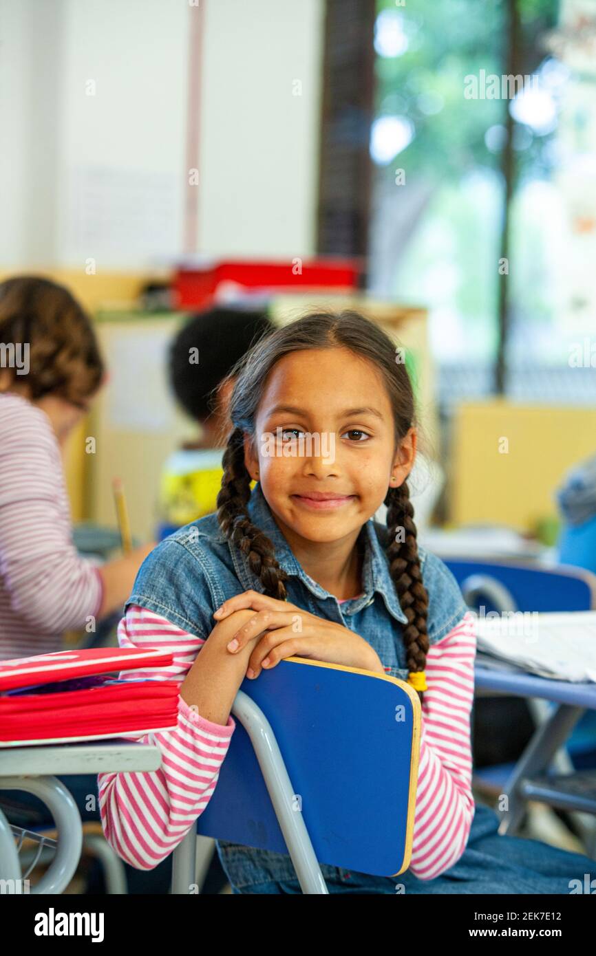 Young girl looking to camera in a school classroom Stock Photo - Alamy