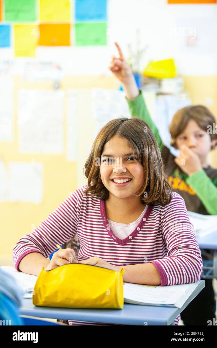 Young girl looking to camera in a school classroom Stock Photo - Alamy