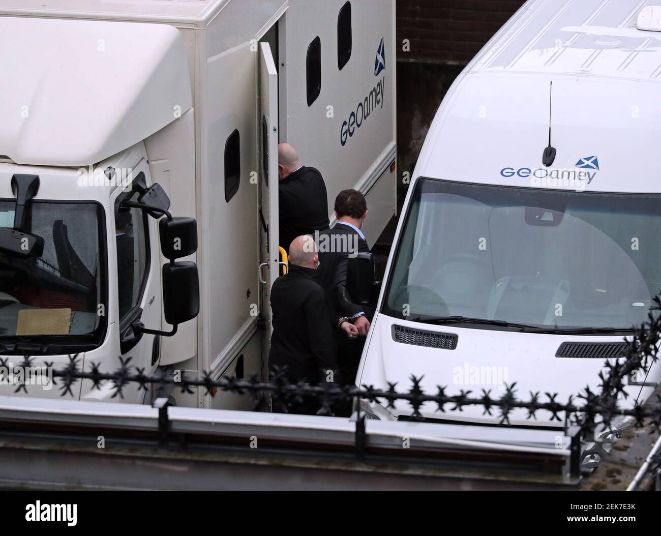 Simon Bowes-Lyon (centre), the Earl of Strathmore, is escorted in handcuffs into a prison van at Dundee Sheriff Court. Bowes-Lyon, 34, has been jailed for 10 months for sexually assaulting a woman in a bedroom at his ancestral home, Glamis Castle in Angus. Picture date: Tuesday February 23, 2021. Stock Photo