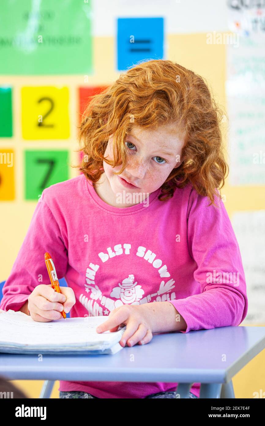 Young girl looking to camera in a school classroom Stock Photo - Alamy