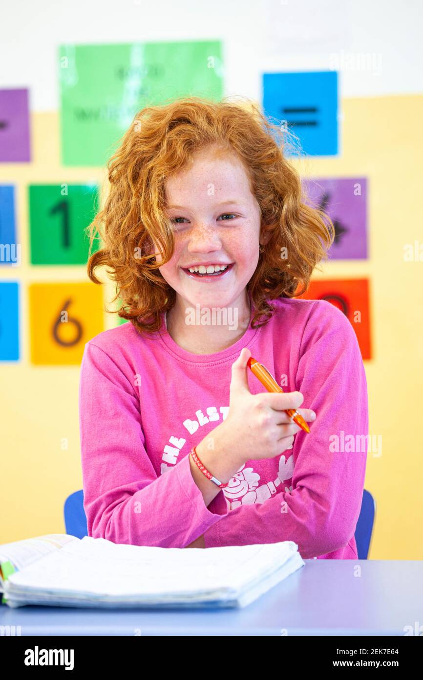 Young girl looking to camera in a school classroom Stock Photo - Alamy