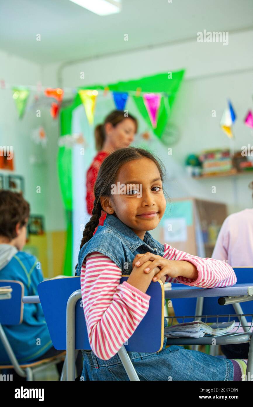 Young girl looking to camera in a school classroom Stock Photo - Alamy