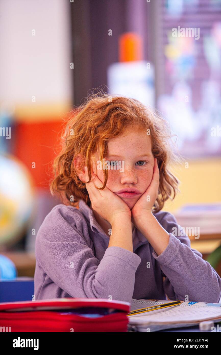 Young girl looking to camera in a school classroom Stock Photo - Alamy