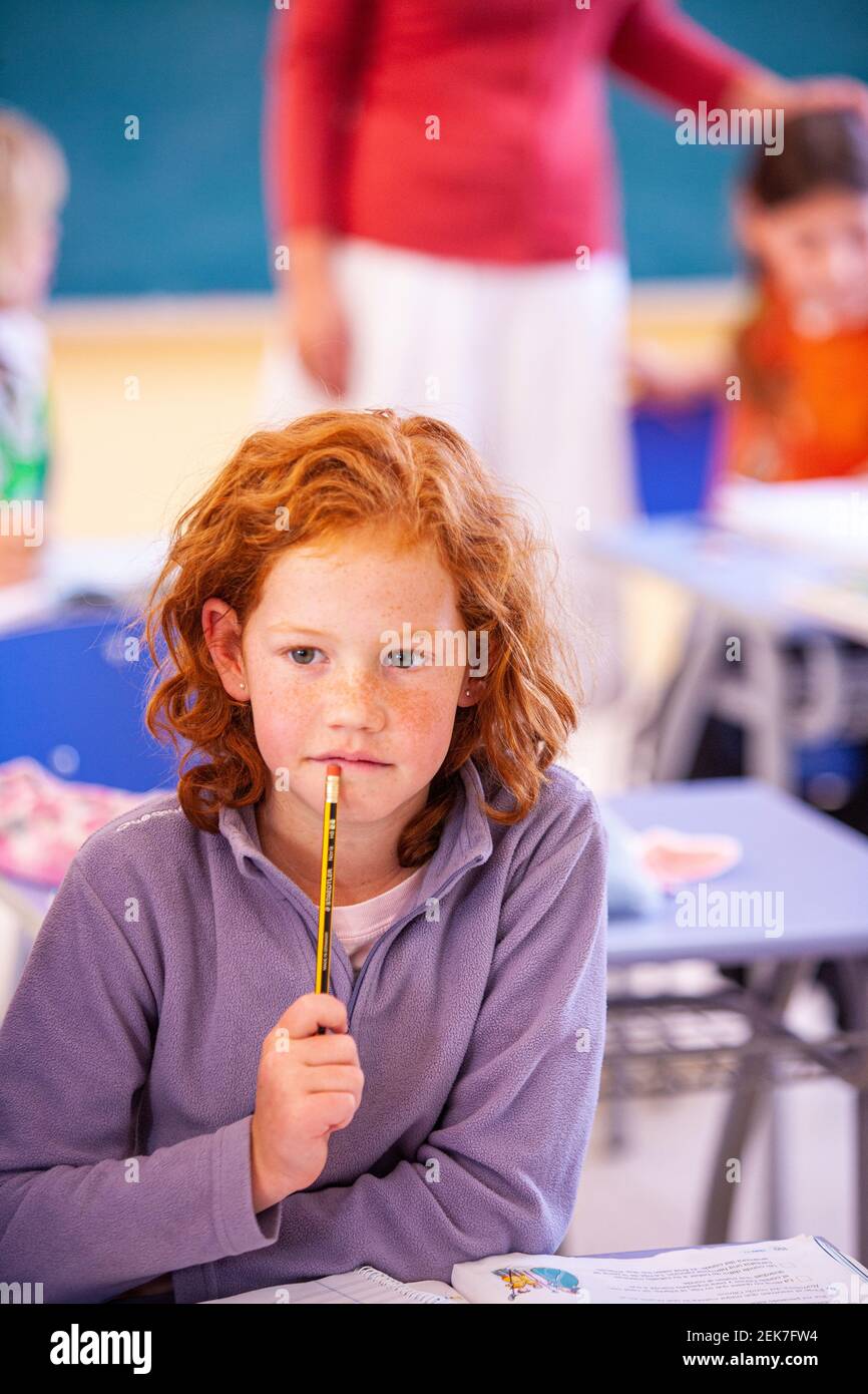 Young girl looking to camera in a school classroom Stock Photo - Alamy