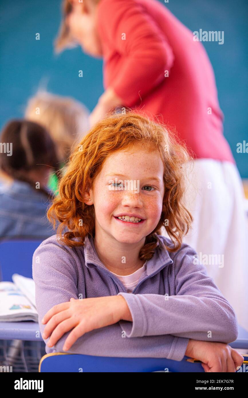 Young girl looking to camera in a school classroom Stock Photo - Alamy