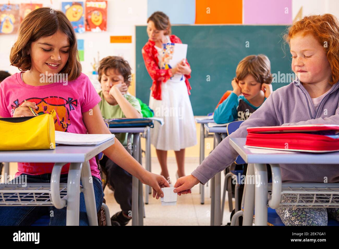 Children cheating in a school classroom Stock Photo