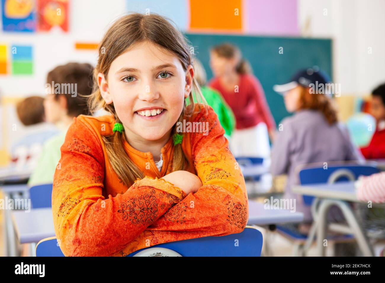 Young girl looking to camera in a school classroom Stock Photo - Alamy