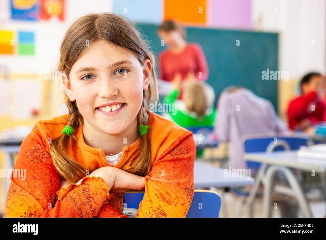Young girl looking to camera in a school classroom Stock Photo - Alamy