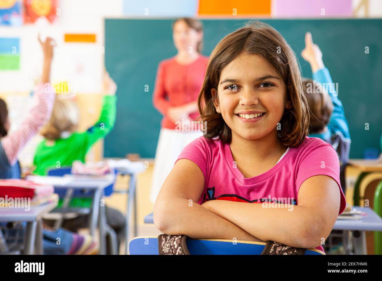 Young girl looking to camera in a school classroom Stock Photo - Alamy