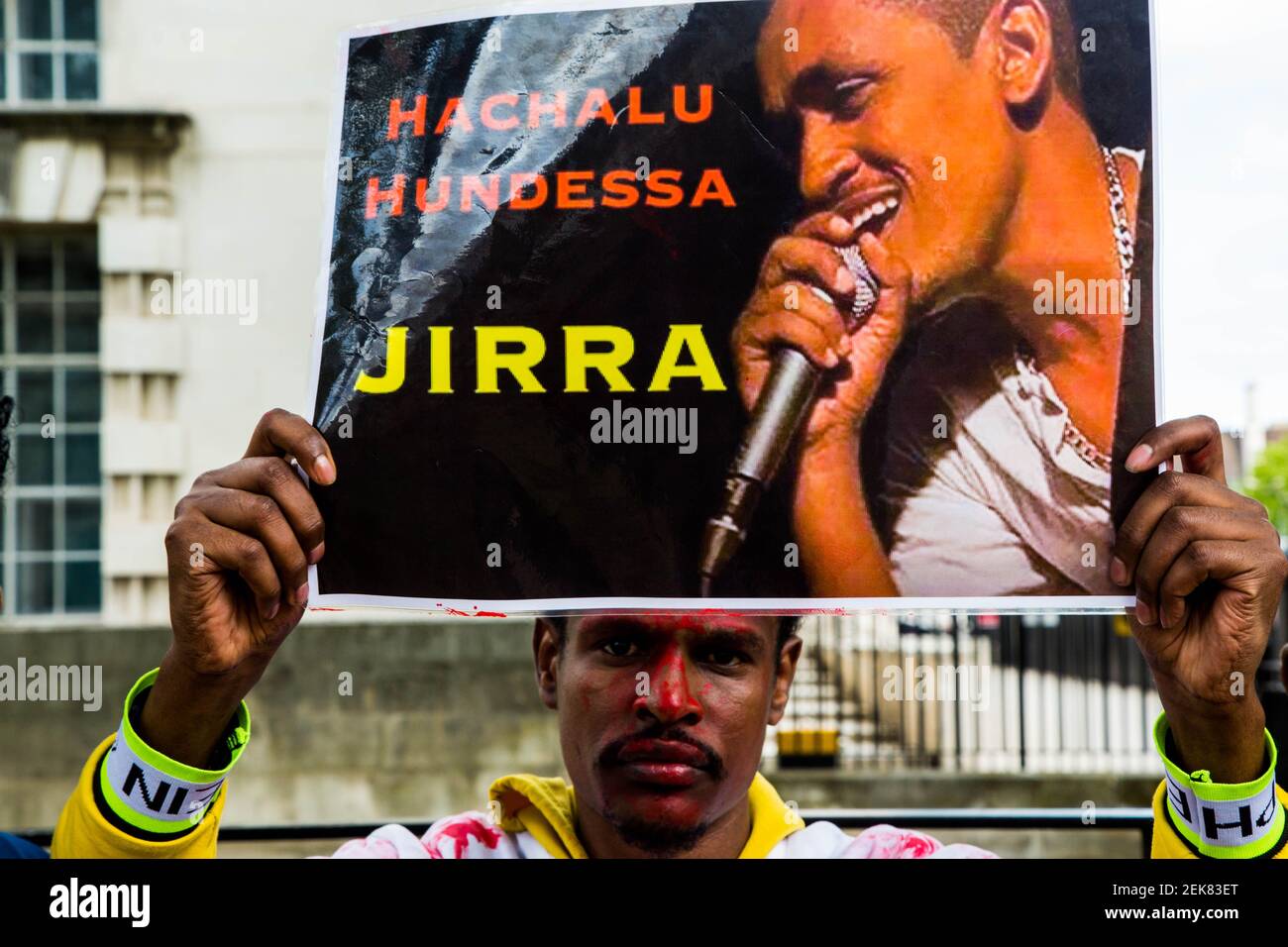 A protester holding a portrait of Haacaaluu Hundeessaa during the ...