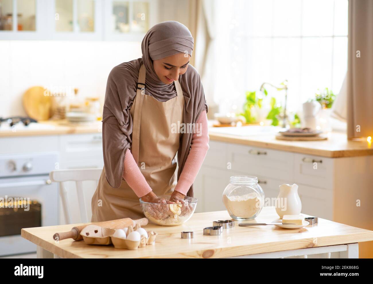 Young Islamic Woman In Hijab Preparing Pastry In Kitchen, Kneading Dough Stock Photo Alamy