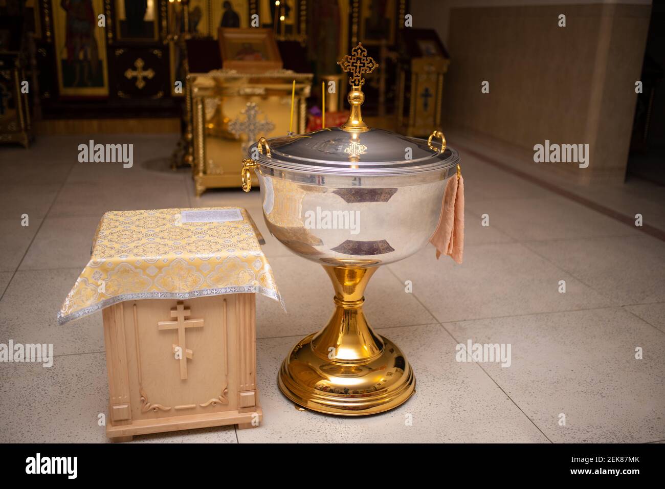 Baptism in the font. Sacrament of baptism. Christening candle. Holy