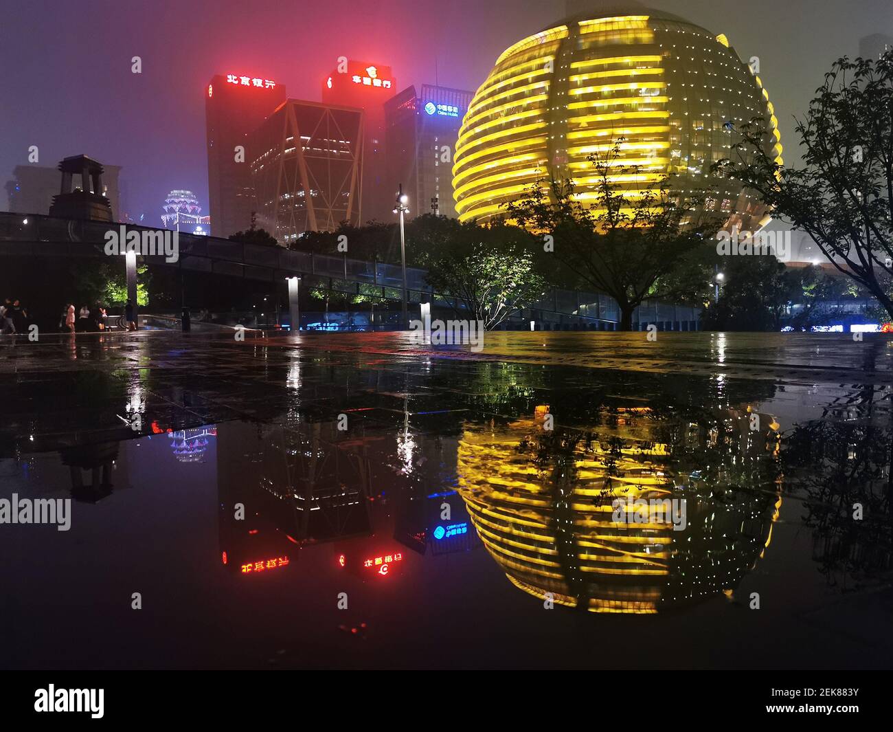 Buildings with LED lights on and their reflections on the Qiantang ...