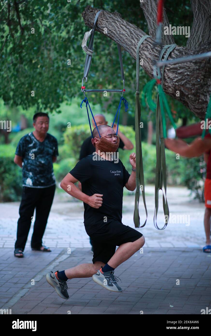 A person does 'face-hanging workout' at a park in Shenyang city, northeast  China's Liaoning province, 5 July 2020. "Face-hanging Workout" has sprung  up in northeast China's Shenyang city. Acoording to 56-year-old Sun