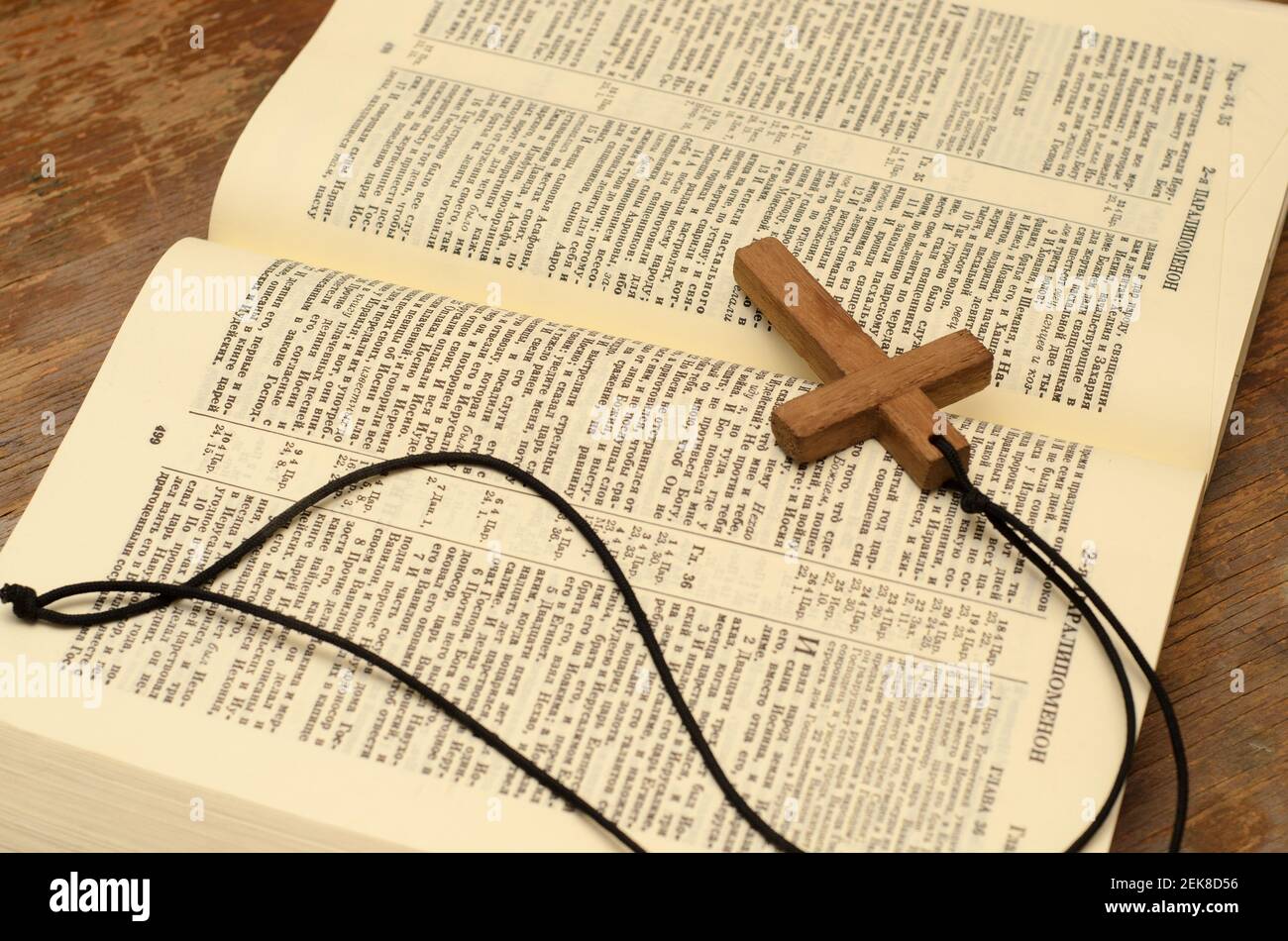 Wooden christian cross with rope on open holy bible Stock Photo Alamy