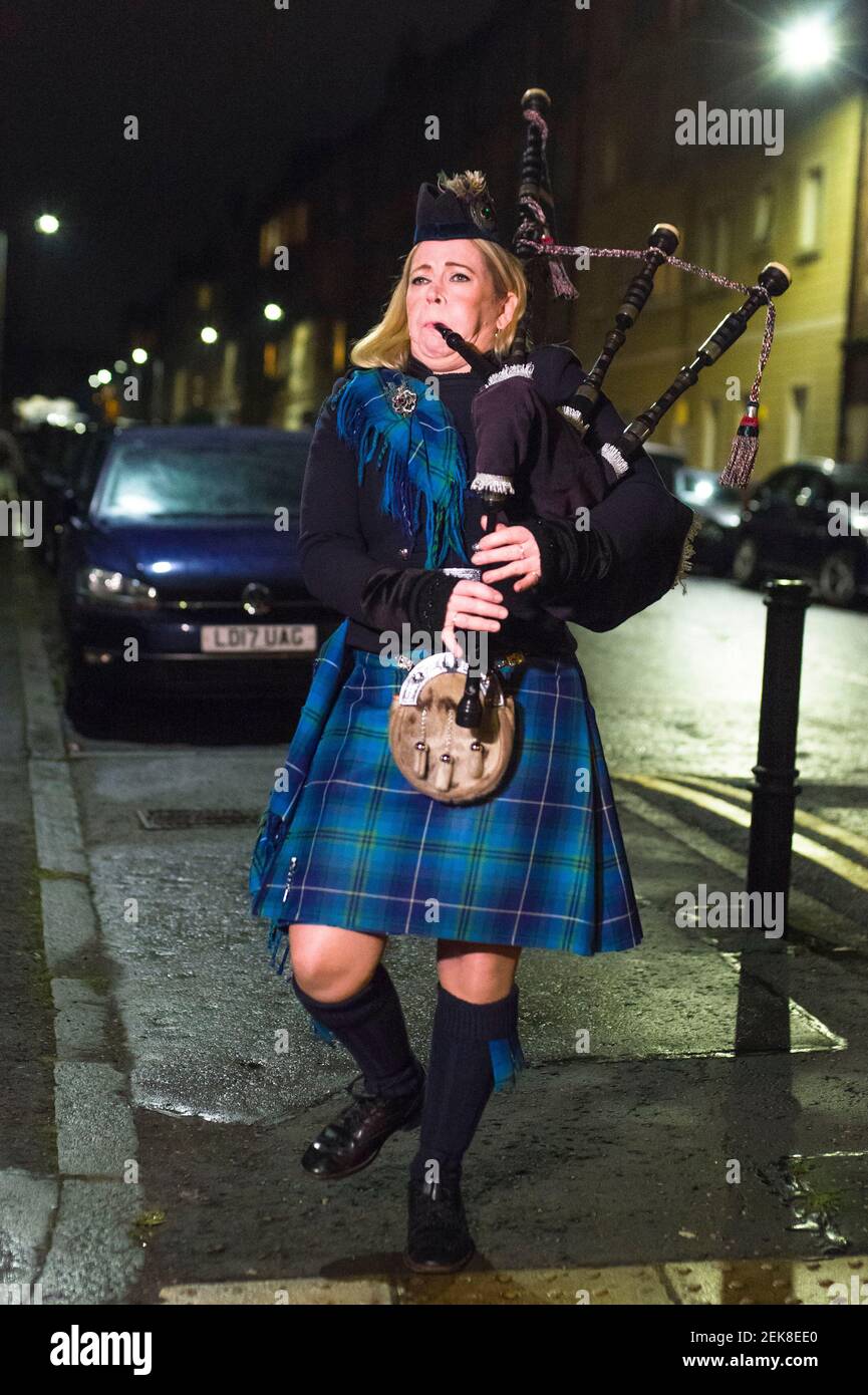 Piper Louise Marshall performs on her bagpipes and neighbors on
