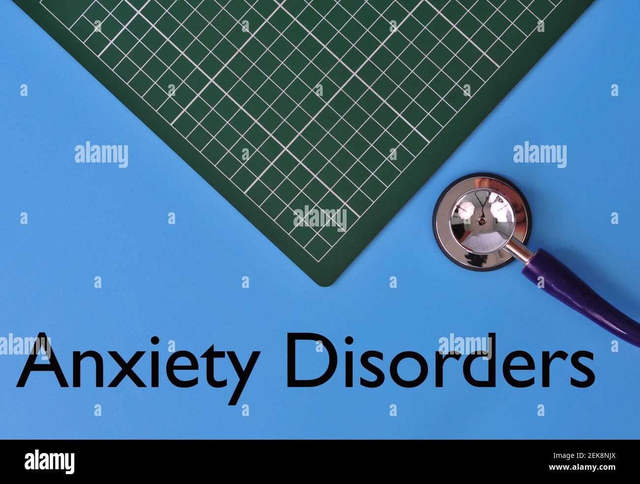 Layout of Stethoscope and graph pad with the text ANXIETY DISORDER on blue background Stock Photo