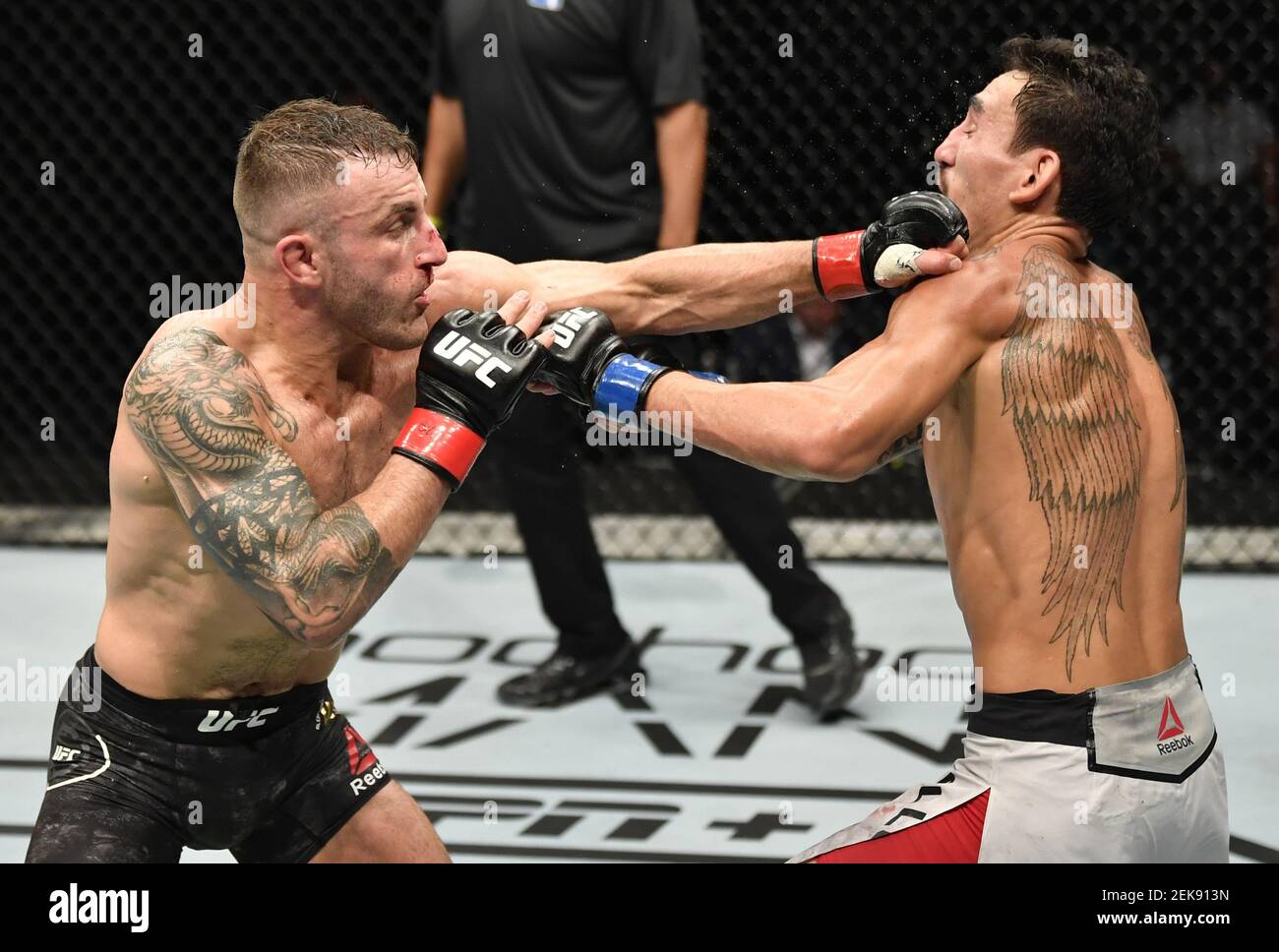 July 12 Abu Dhabi Uae Alexander Volkanovski Of Australia Punches Max Holloway In Their Ufc Featherweight Championship Fight During The Ufc 251 Event At Flash Forum On Ufc Fight Island On