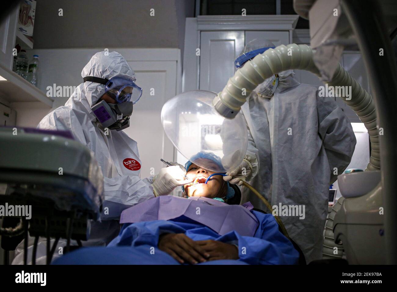 dentist-masayu-l-and-assistant-who-are-both-wearing-full-ppe-outfits