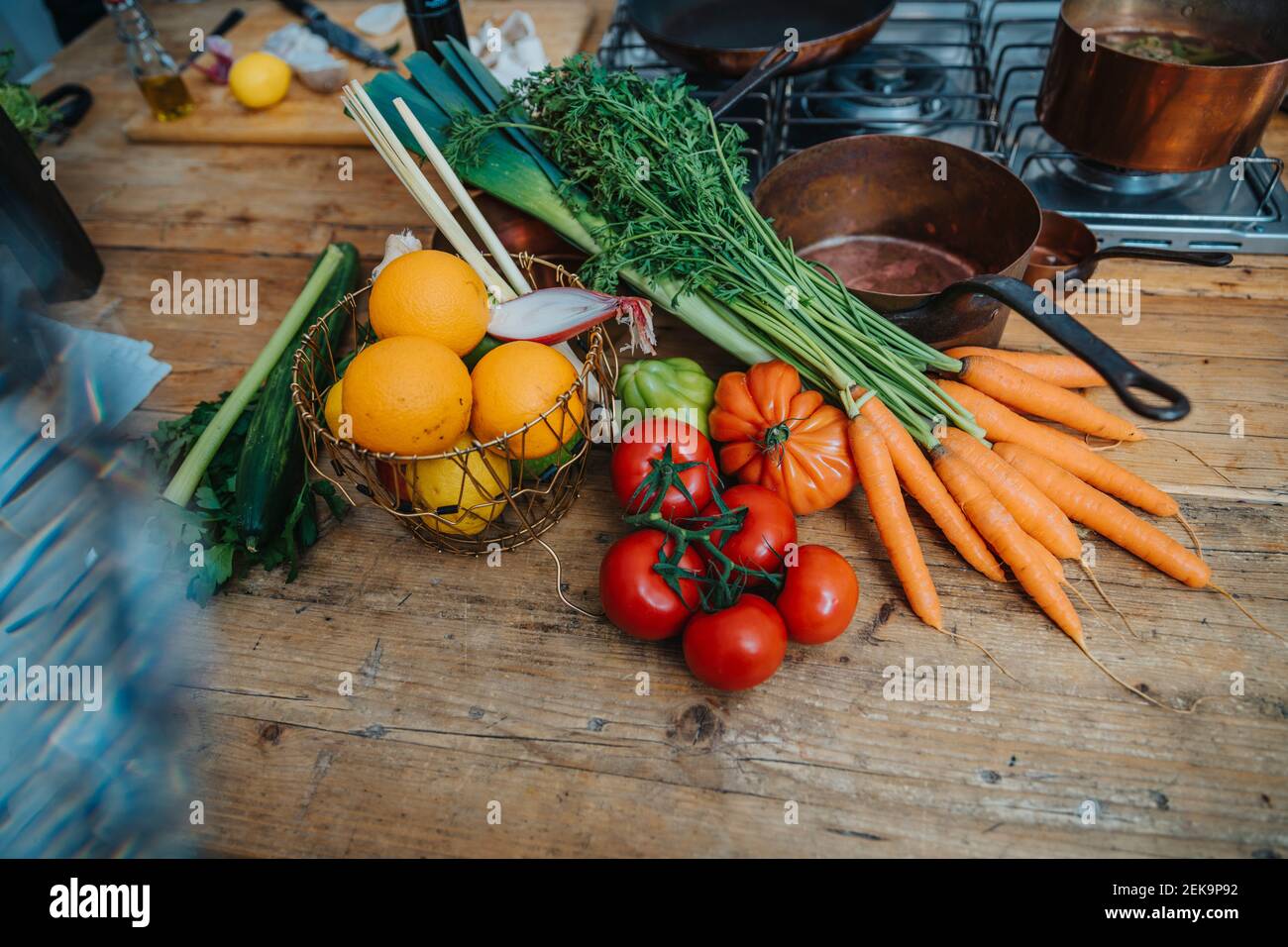 Fruits and vegetables by kitchen utensil on kitchen island Stock Photo