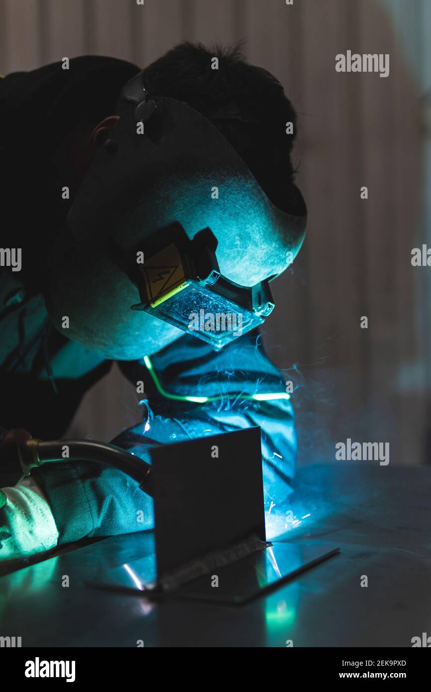 Young professional welder welding at workshop Stock Photo
