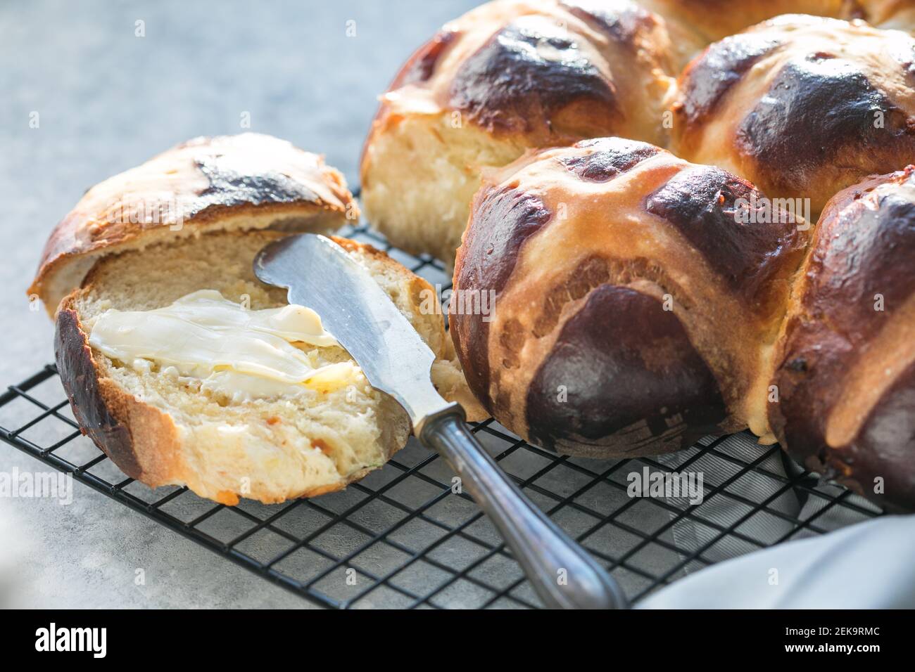 Hot cross buns with butter.  Traditional easter treat Stock Photo