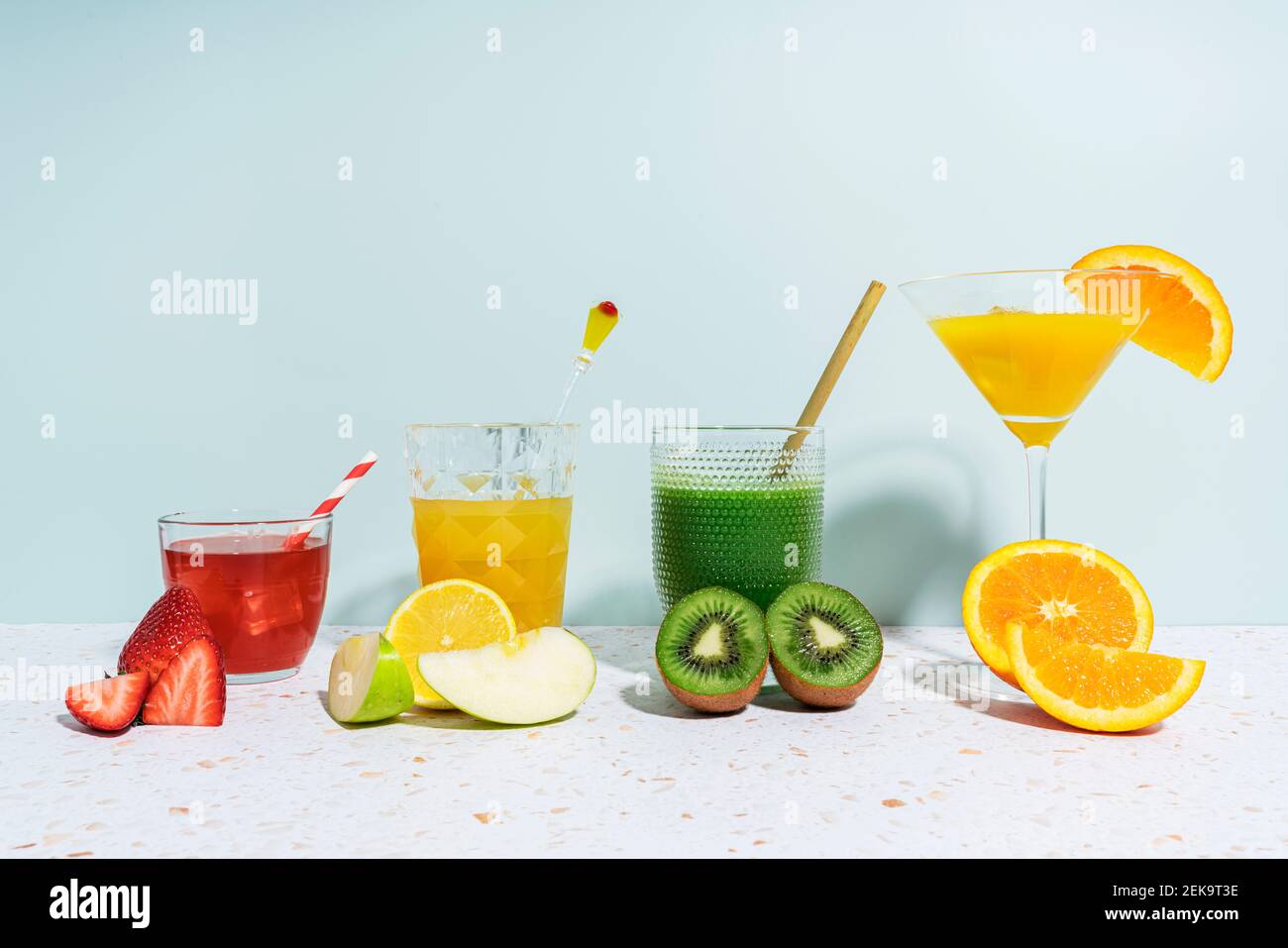 Healthy fruit juices on terrazzo marble against wall at home Stock Photo