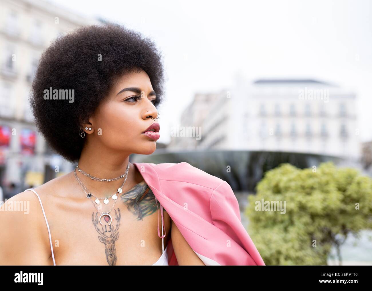 Thoughtful young woman looking away outdoors Stock Photo