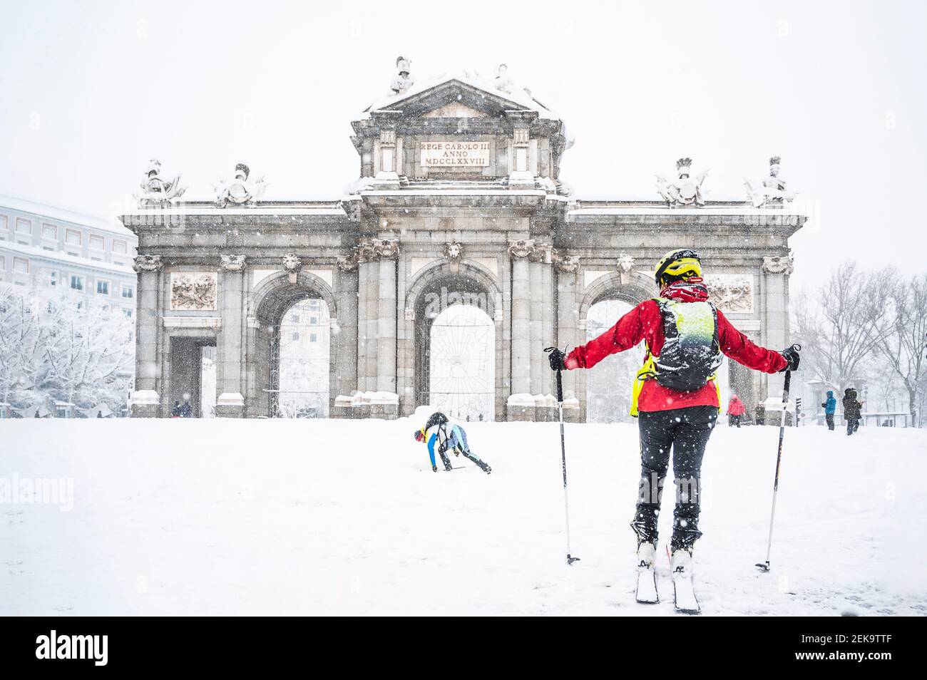 Man and woman skiing on snow against Alcala Gate during Storm Filomena in  2021 at Madrid, Spain Stock Photo - Alamy