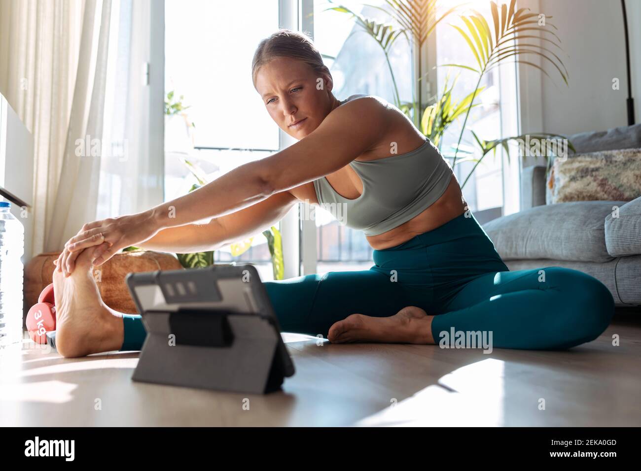 Woman sitting on floor stretching hi-res stock photography and images ...