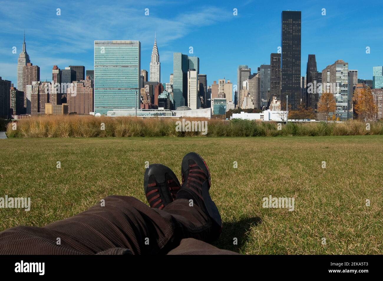 Low section view of a person in a park with Manhattan skyline in the background, New York City, New York State, USA Stock Photo