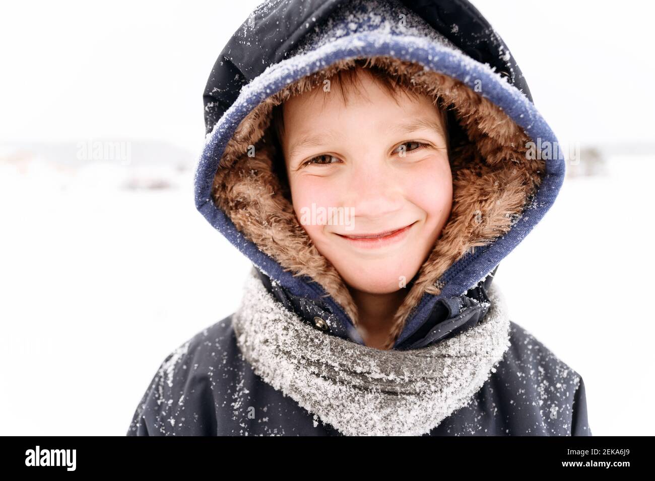 Close-up portrait of smiling boy wearing warm clothing Stock Photo