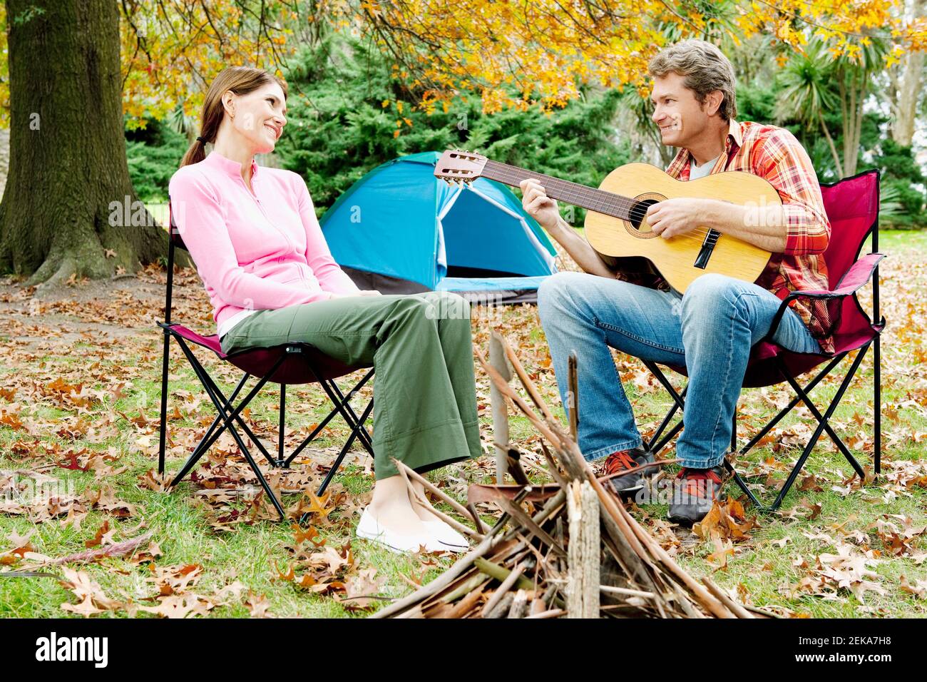 Couple with a guitar in a park Stock Photo