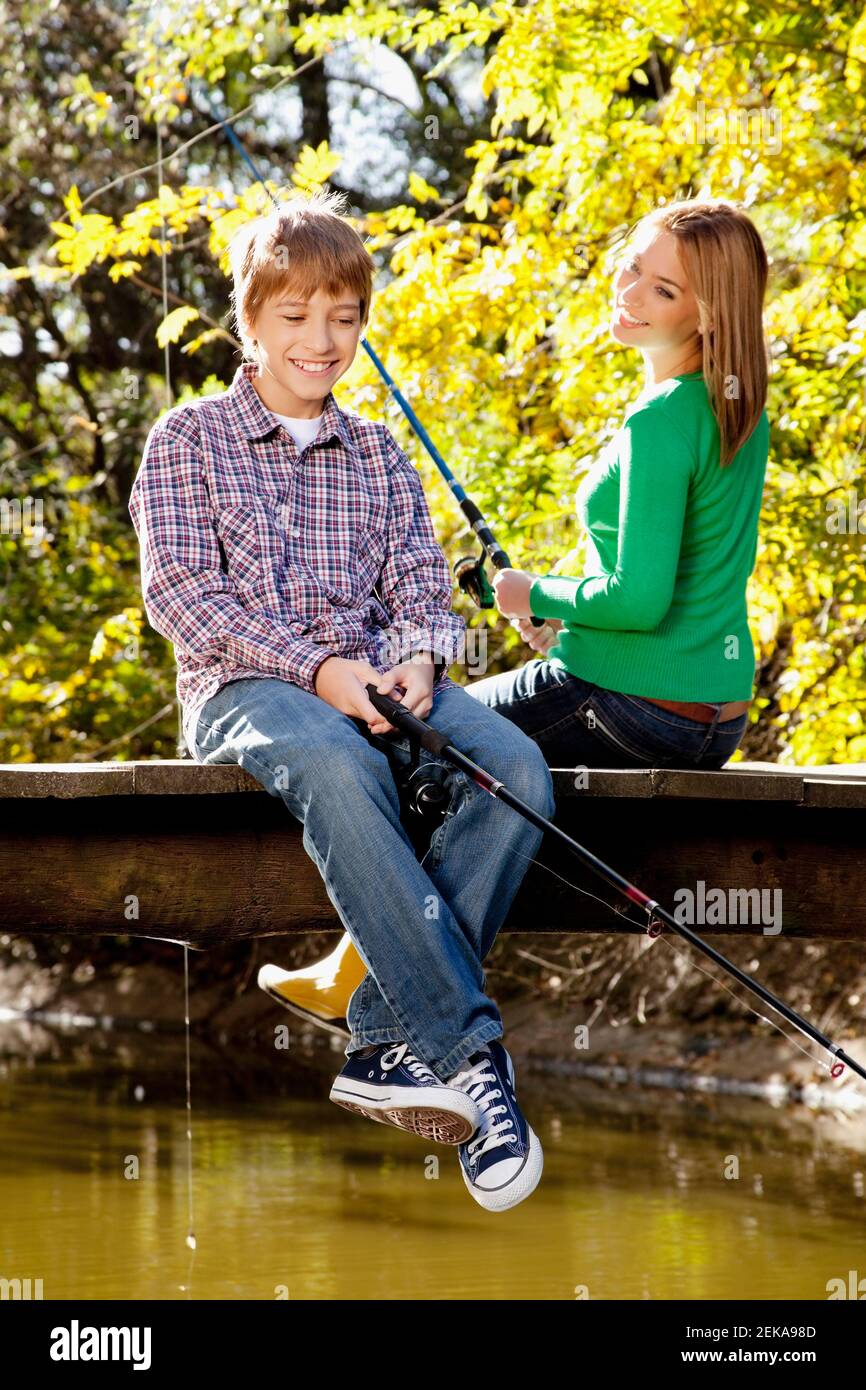 Boy fly fishing with his mother Stock Photo
