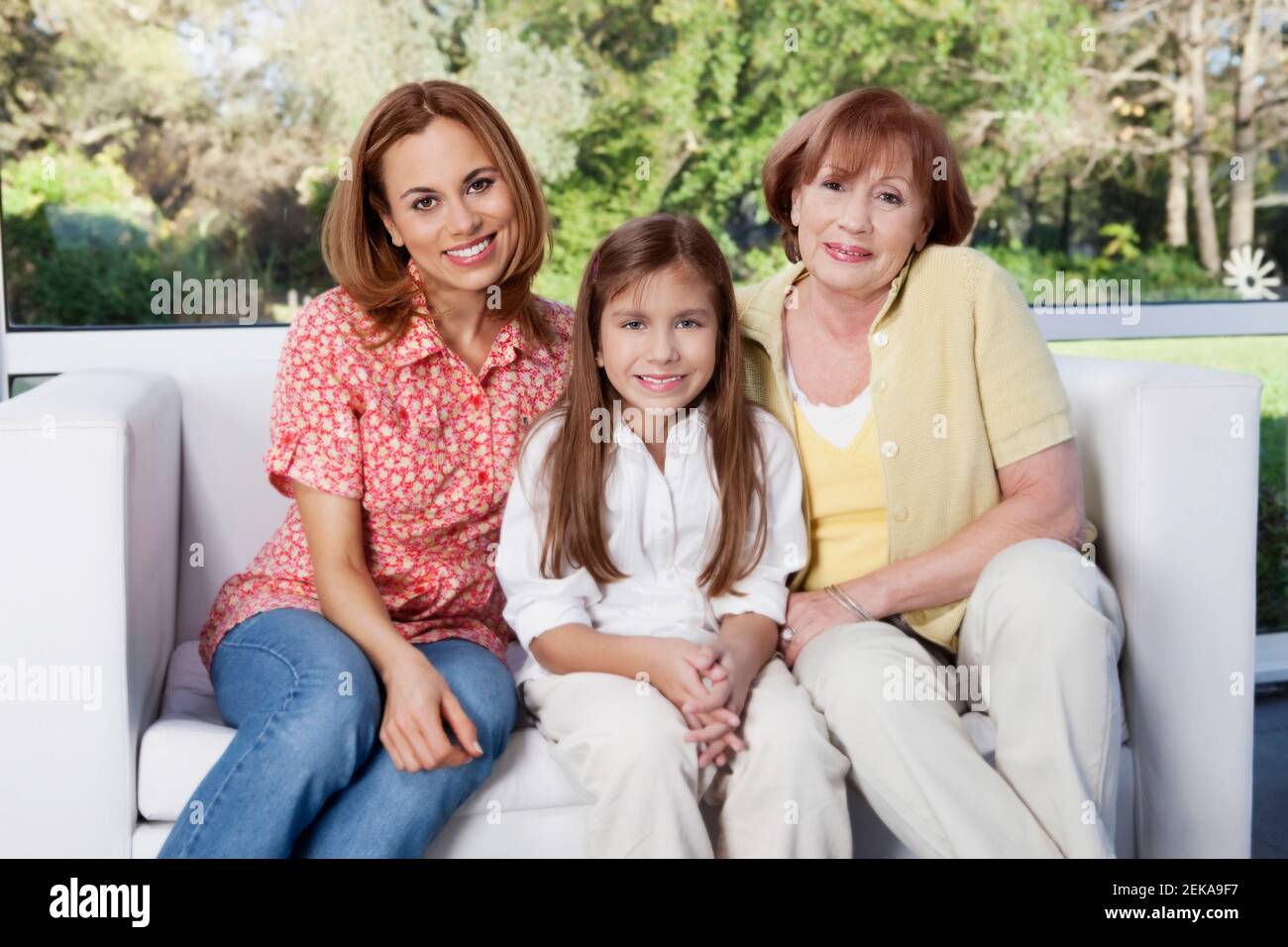 Portrait of a girl sitting with her mother and grandmother Stock Photo ...