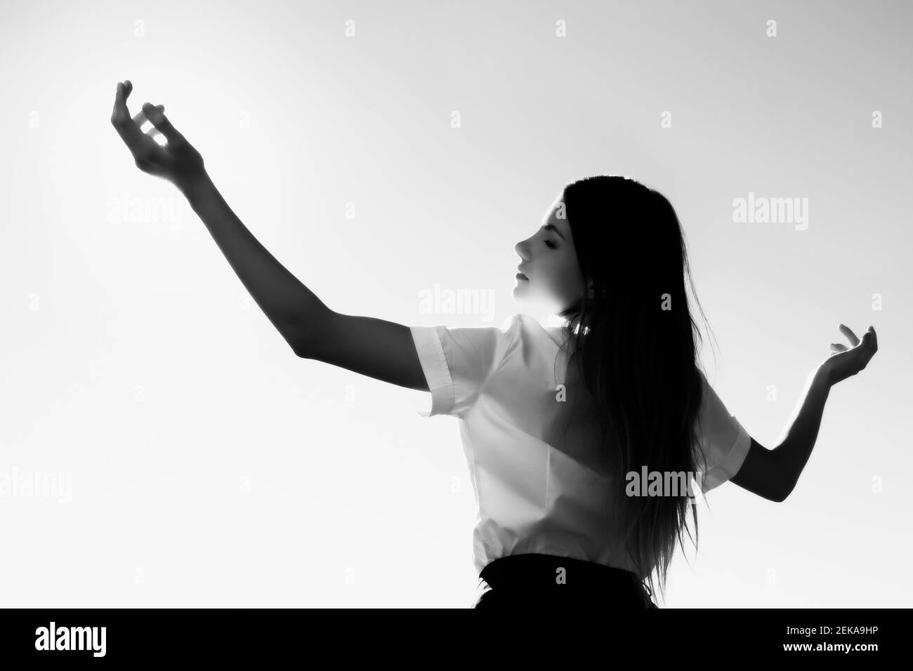 Teenage girl standing with her arms outstretched Stock Photo