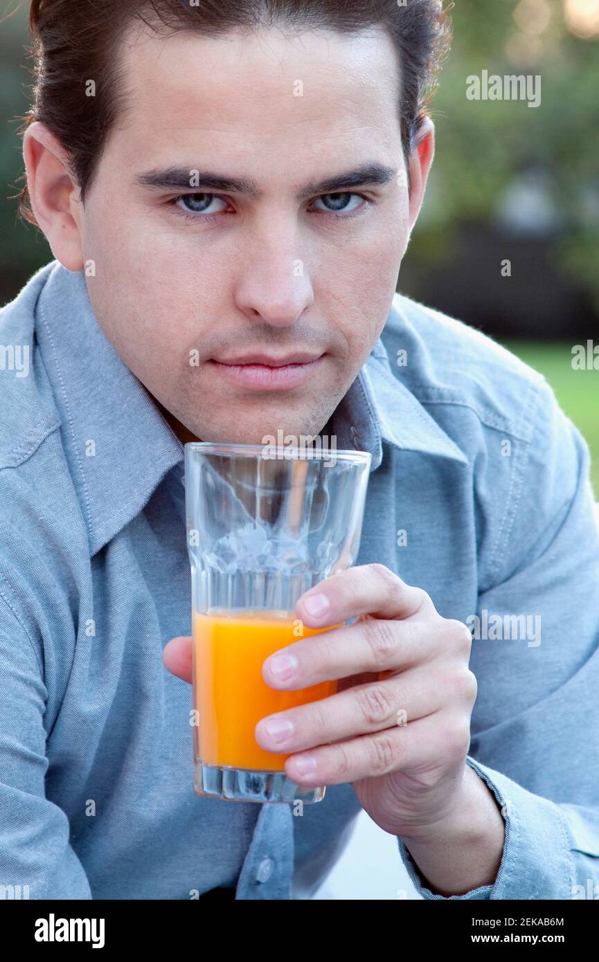 Man drinking orange juice Stock Photo Alamy