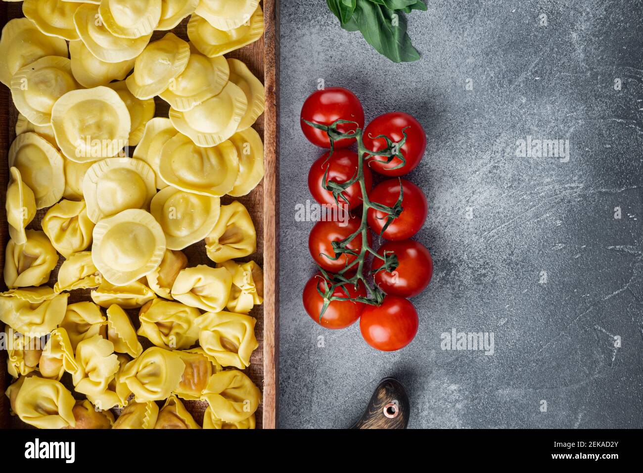 Italian raw handmade Ravioli with fresh ingredients, basil, pesto, ham