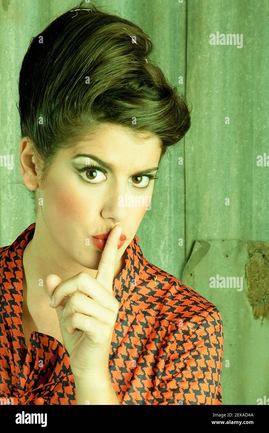 Portrait of a woman with finger on lips Stock Photo - Alamy