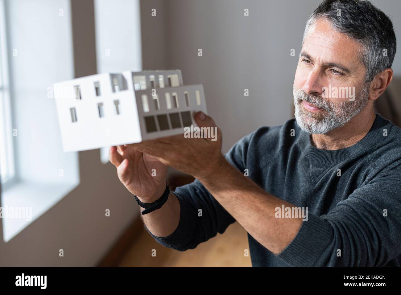 Architect holding architectural model while standing at home Stock Photo
