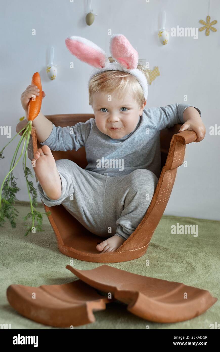Funny young toddler boy in rabbit ears Easter traditions Stock Photo