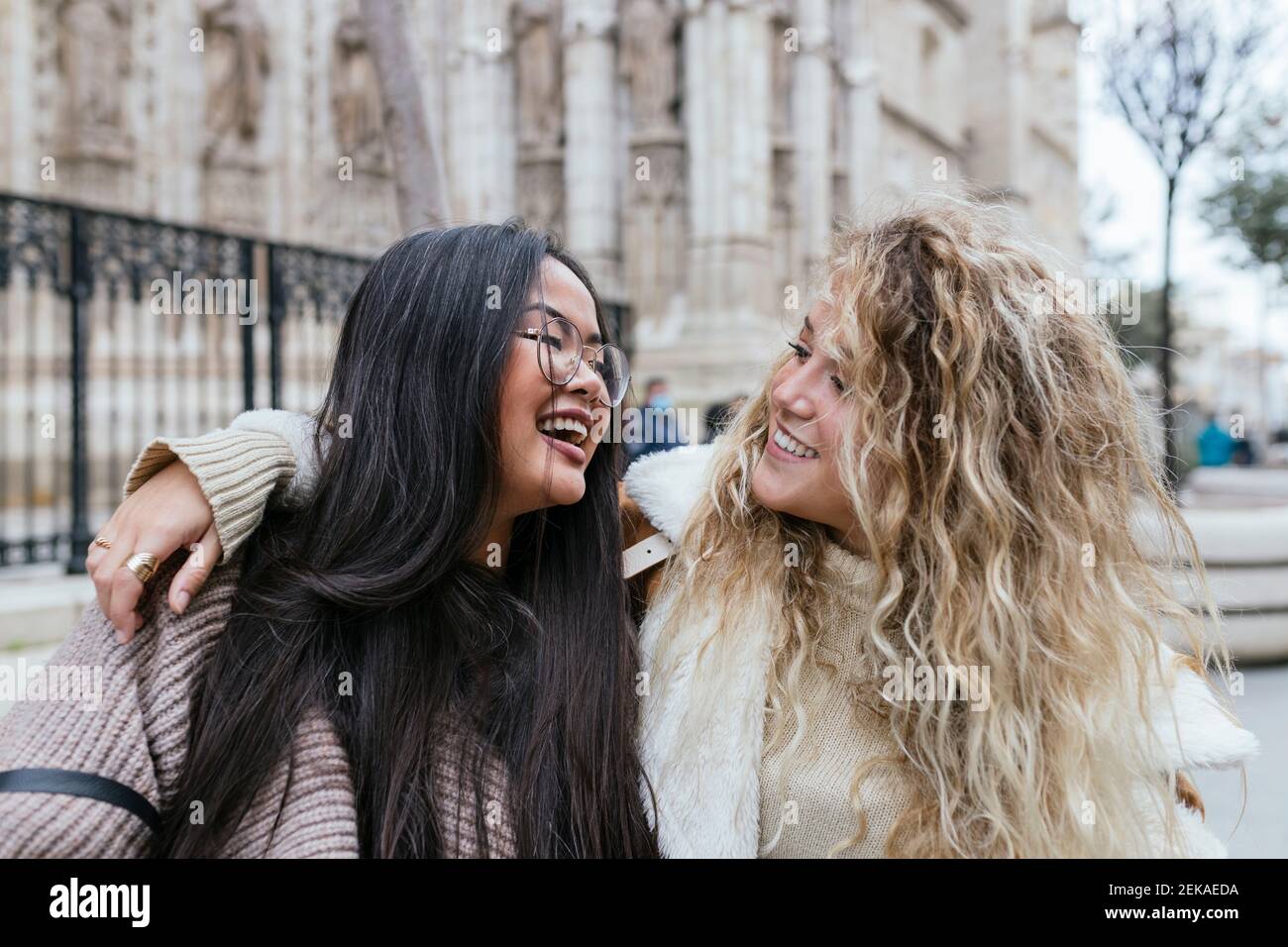 Young women arms around each other hi-res stock photography and images ...