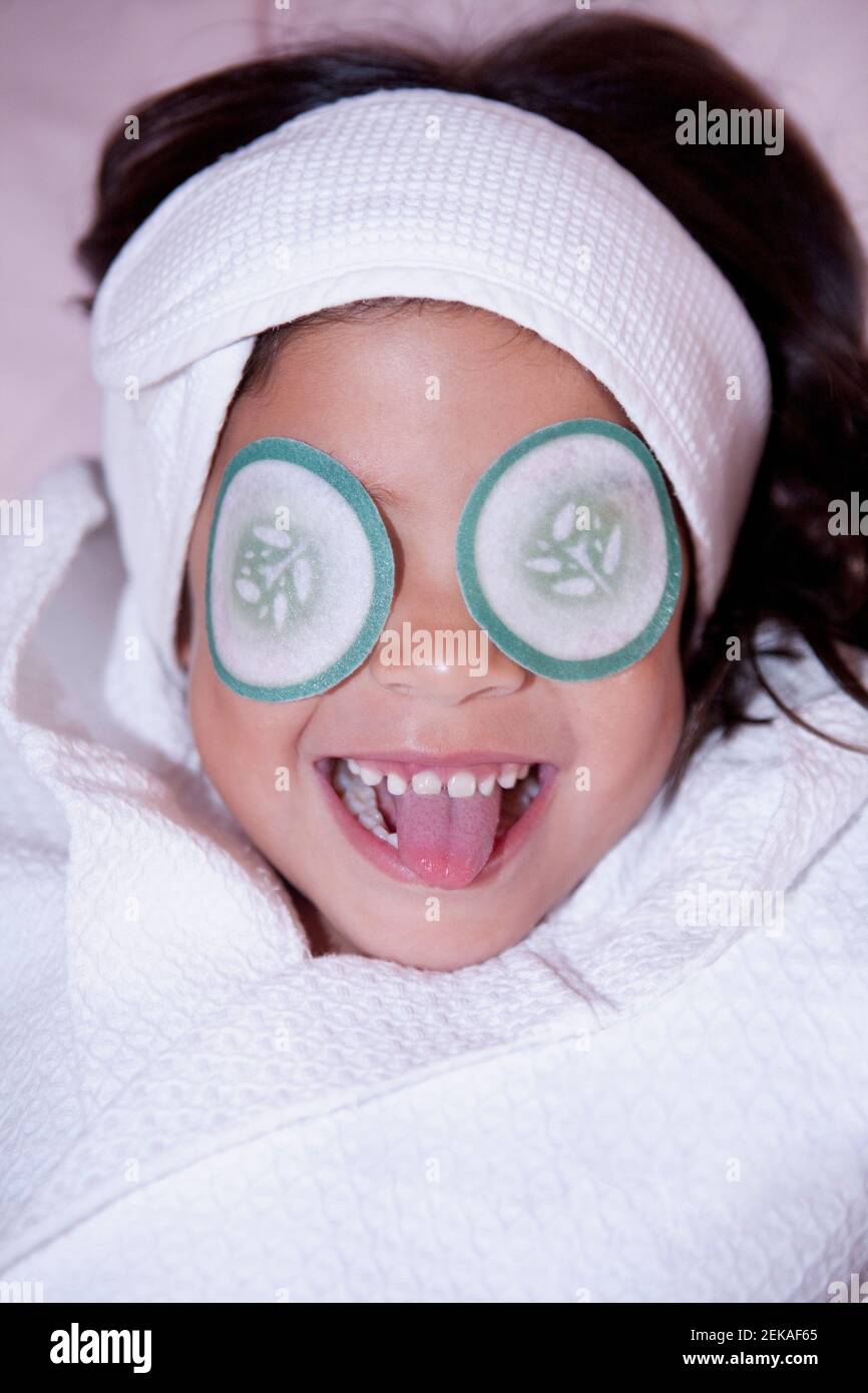 Cucumber slice shape eye pads on a girlÅ½s eyes Stock Photo