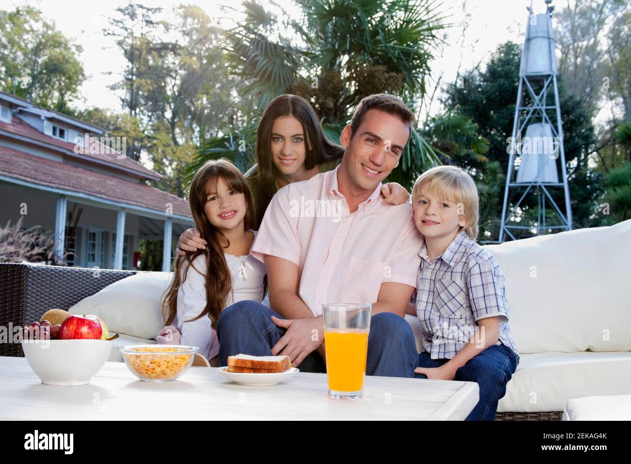 Portrait of a family sitting on a couch Stock Photo - Alamy