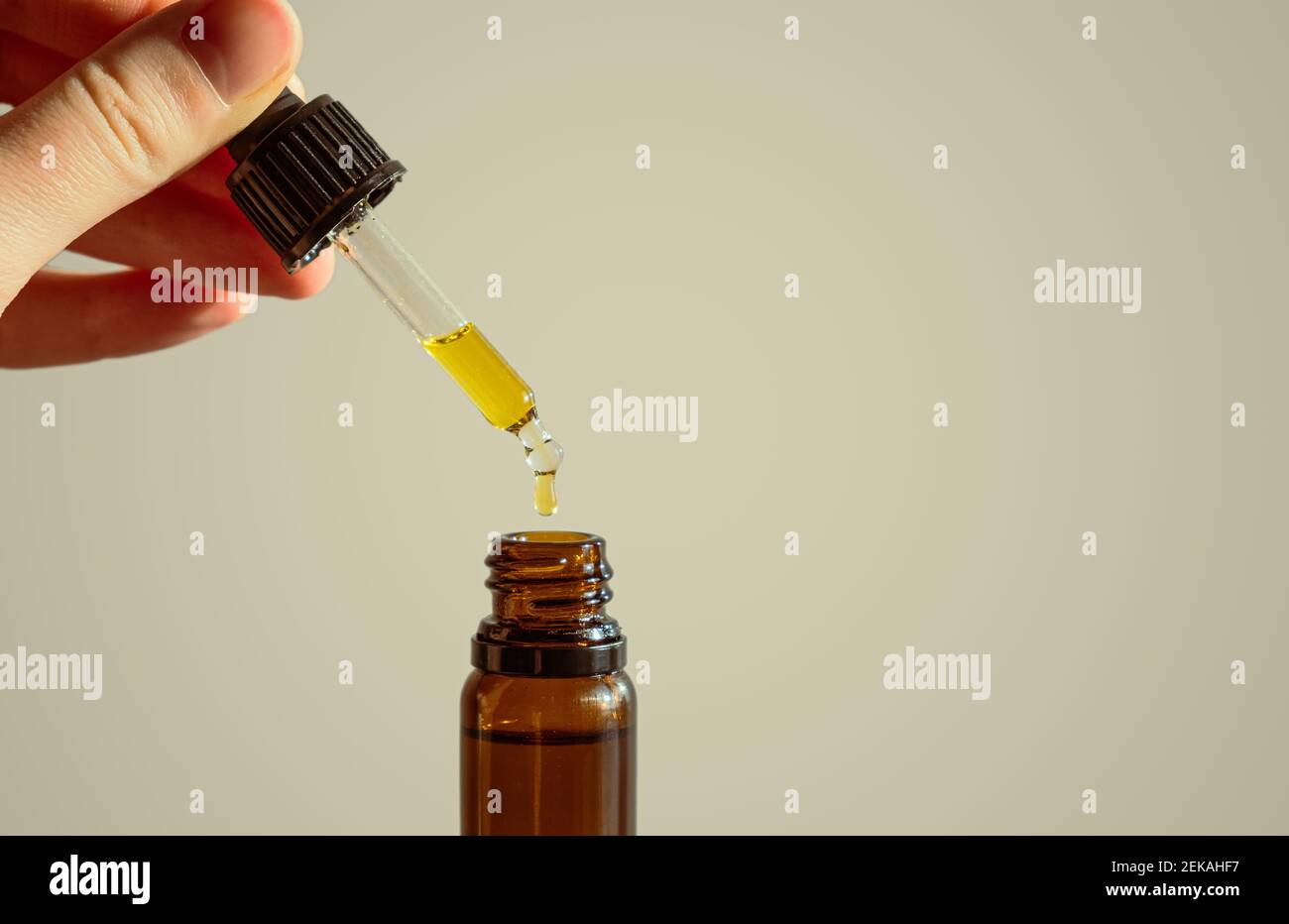 Dropper of cbd or thd oil in human hands. Essential oil, natural health products, calming supplements Stock Photo