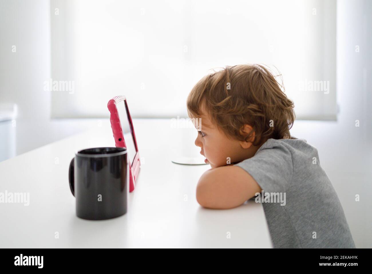 Father and son using digital tablets in kitchen Stock Photo