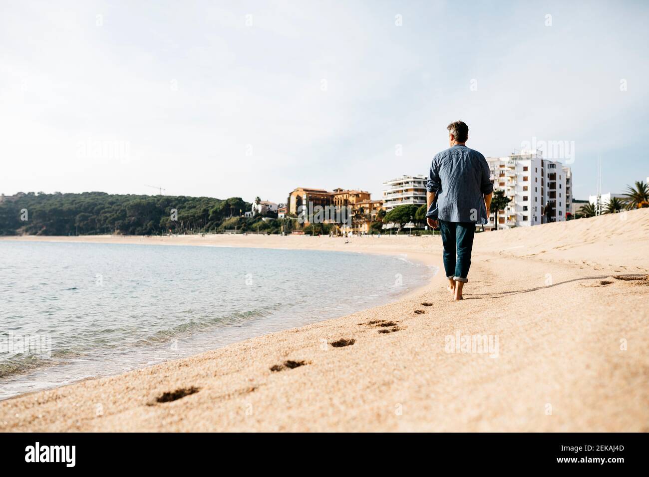 Man walking on beach hi-res stock photography and images - Alamy